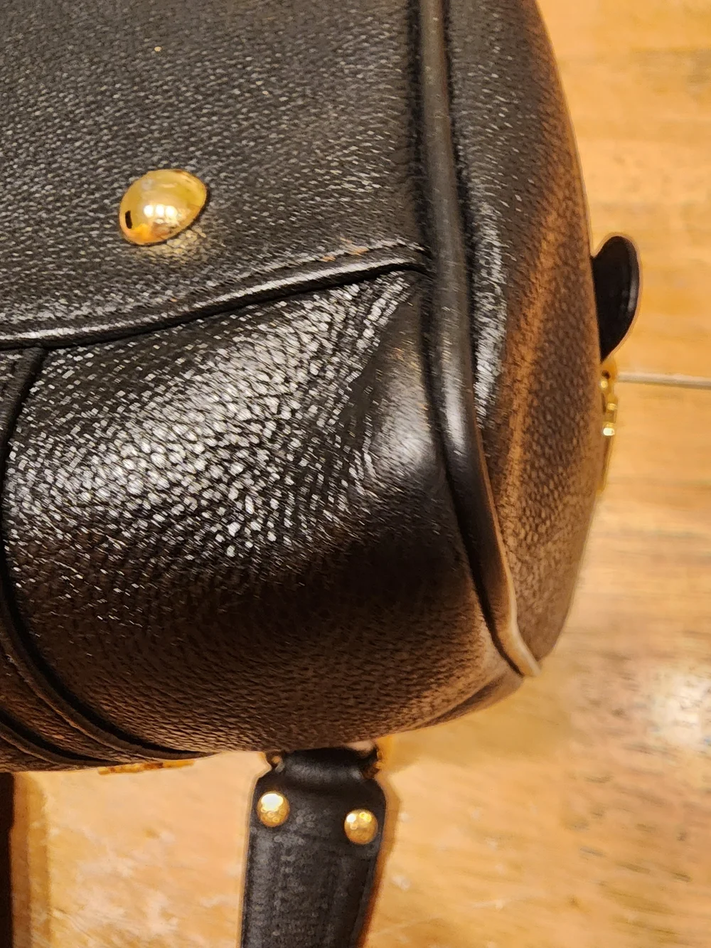 MCM Black Leather Boston Bag featuring polished gold-tone hardware